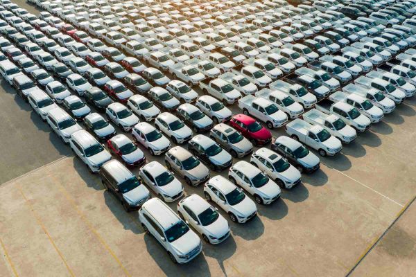 Luftaufnahme eines Parkplatzes mit vielen Autos zur Auslieferung.